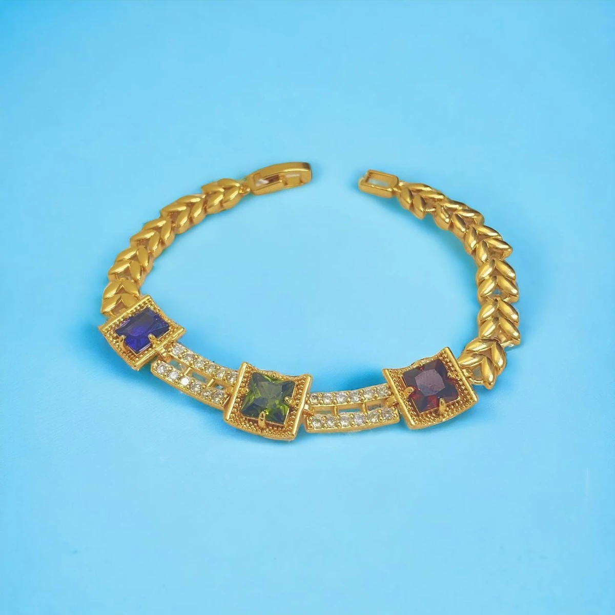 Golden Majesty: A Shining Gold imitation Bracelet Embellished with Intricately Set Gemstones and Square Links