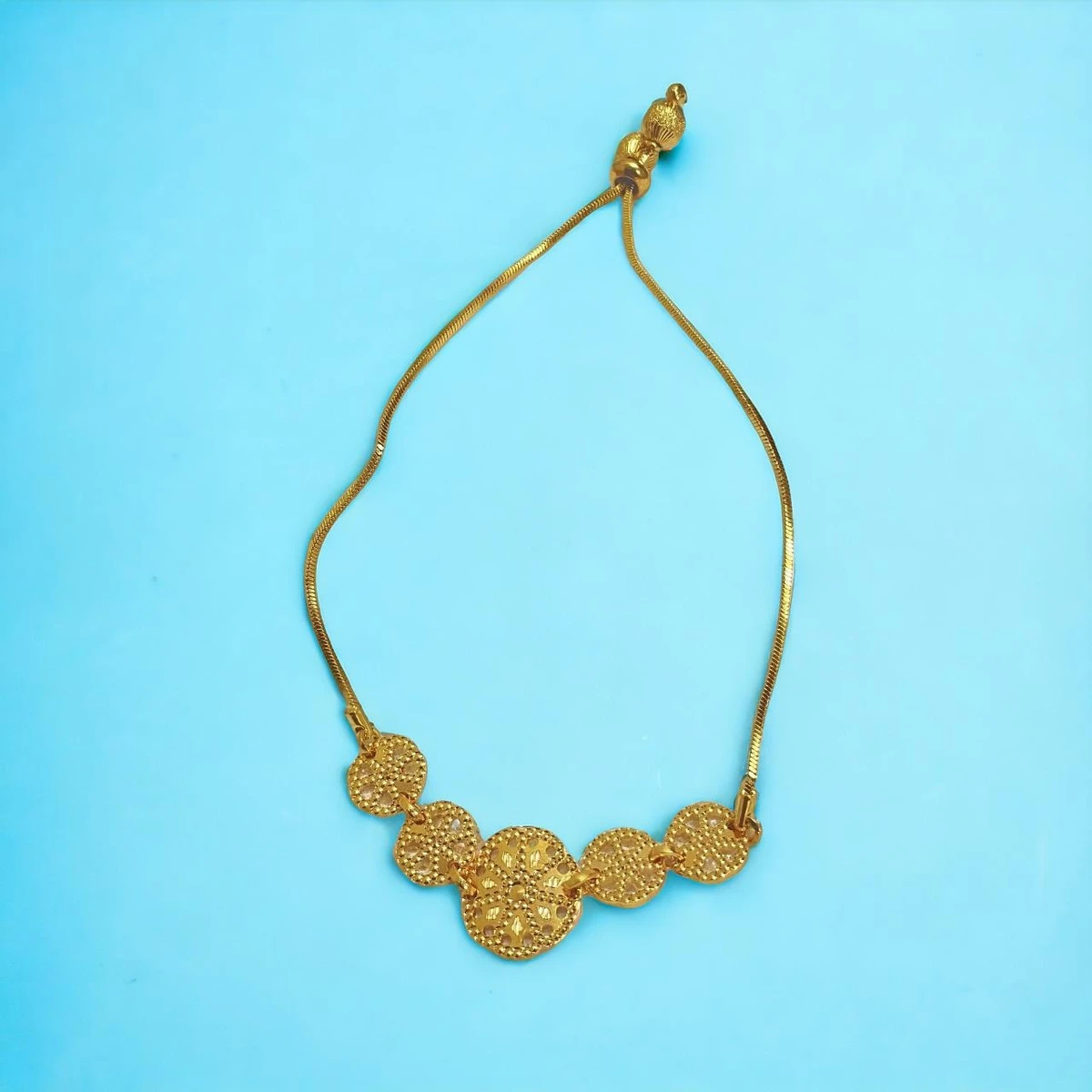 Radiant Reflections: A Golden Bracelet Adorned with Intricately Designed Circular Elements