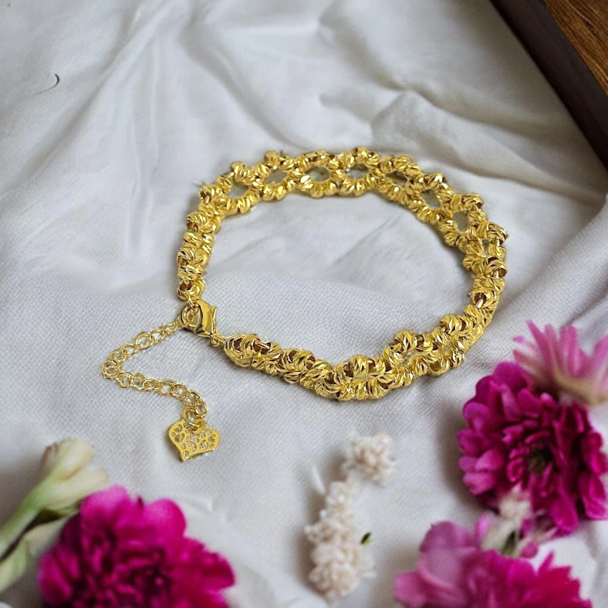 Radiant Majesty: A Divine Bracelet Exuding Stunning Beauty, Embellished with Small, Gleaming Golden Beads