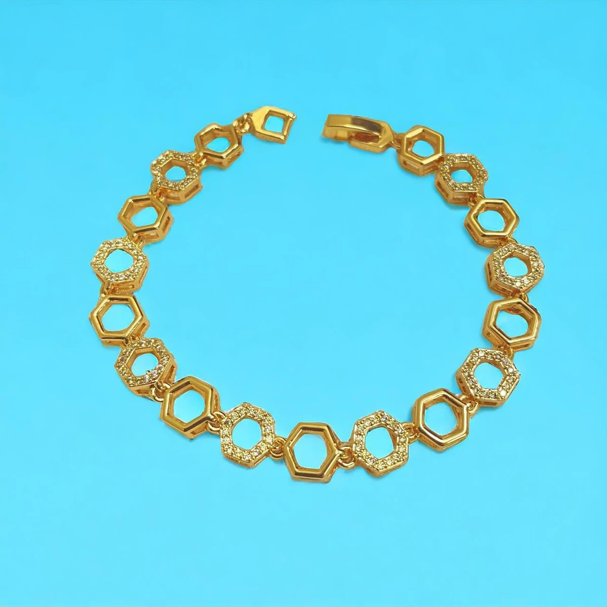Golden Radiance: Luxurious Bracelet with Intricately Patterned Hexagonal Links and Shimmering Stone Embellishments