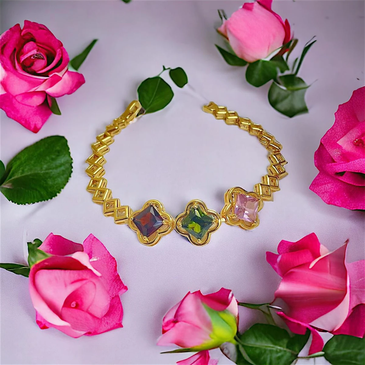 Radiant Elegance: A Delicate Imitation  Gold Bracelet Adorned with Three Colorful Gemstones in Linear Alignment
