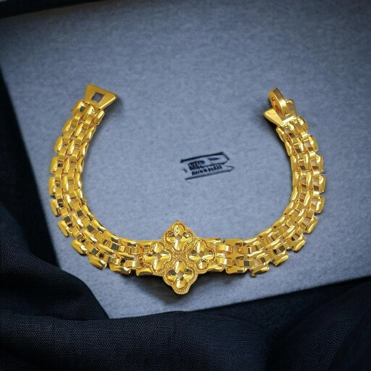 Golden Tapestry: Exquisitely Carved Imitation Gold Bracelet with Interlocking Rectangular Links and Detailed Centerpiece