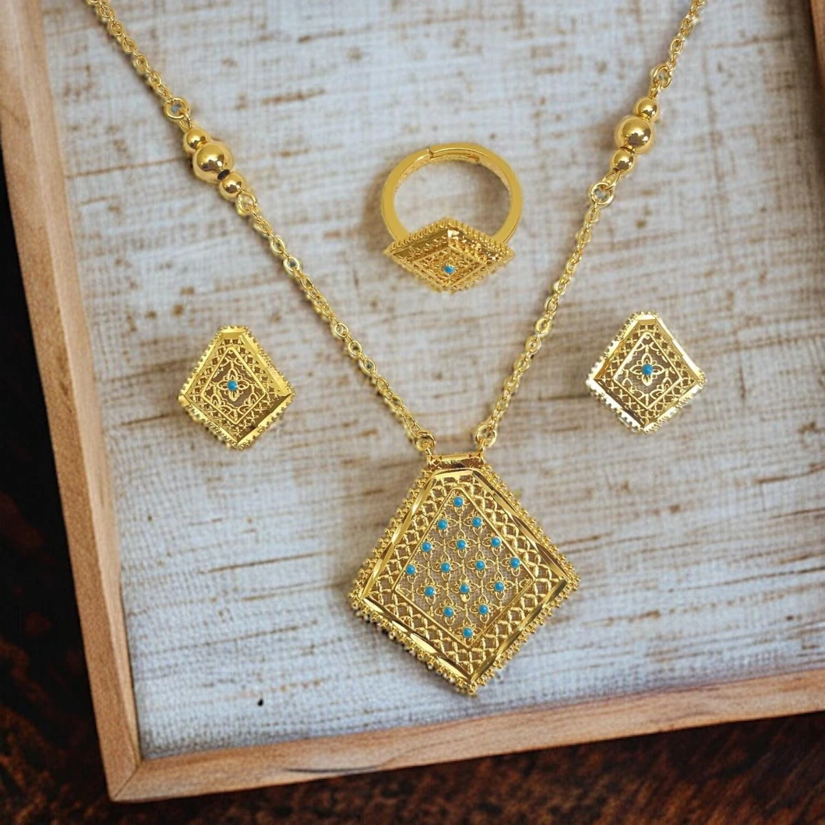 Turquoise Treasures: Exquisite Jewelry Ensemble Embellished with Meticulous Golden Details and Vibrant Turquoise Gemstones