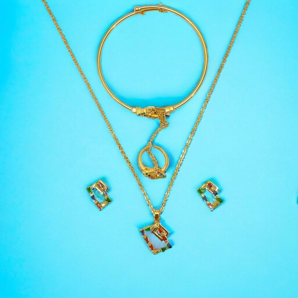 Serene Splendor: Opulent Imitation Gold Necklace, Ring, and Pendant Set with Intricate Designs and Vibrant Accents